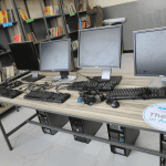 Official handover of books between representatives and donated computers/cabinets