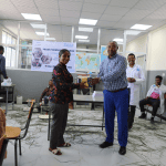 Official handover of books between representatives and donated computers/cabinets
